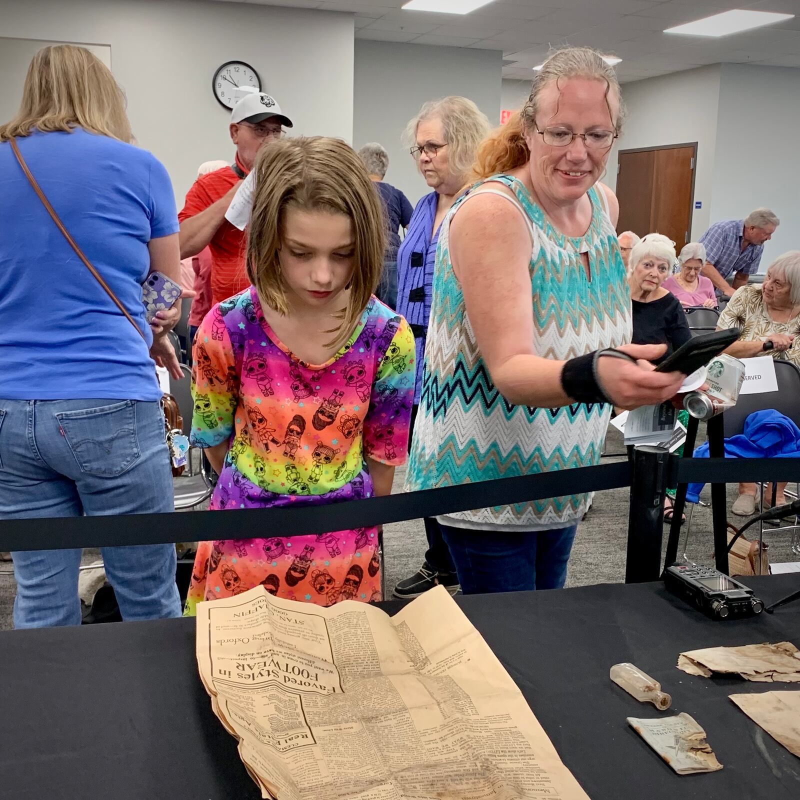 A young girl inspects the June 7, 1915 copy of the Greene County Journal, a newspaper in circulation at the time of the cornerstone laying. LONDON BISHOP/STAFF