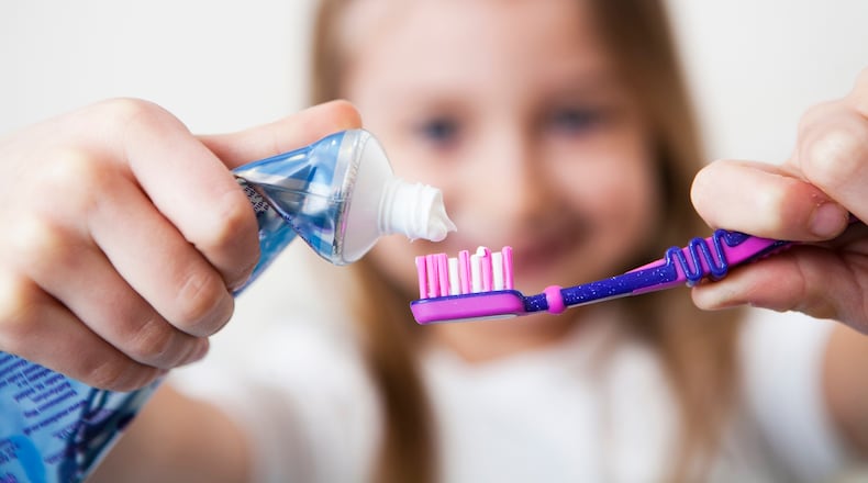 Children may need some help with fun colors and toothbrush styles to get them more into brushing their teeth routinely. iSTOCK/COX