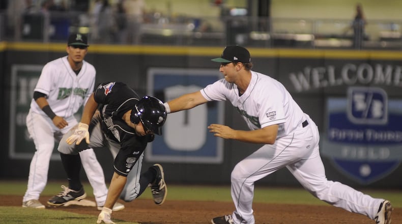 Dragons first baseman Bruce Yari tags out Nick Sinay of the Lugnuts after he was picked off first base. The Dragons (Reds) lost 4-3 to the Lansing Lugnuts (Blue Jays) in a Class A minor-league baseball game at Dayton’s Fifth Third Field on Tuesday, Aug. 8, 2017. MARC PENDLETON / STAFF