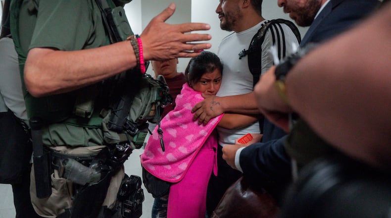 FILE - An asylum seeker from Ecuador hugs her father as he is detained by federal agents, July 31, 2025, in New York. (AP Photo/Olga Fedorova, file)