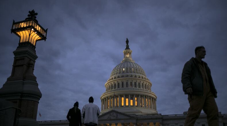 In this Jan. 21, 2018, file photo, lights illuminate the U.S. Capitol on second day of the federal shutdown as lawmakers negotiate behind closed doors in Washington. The era of trillion-dollar budget deficits is about make a comeback _ and a brewing budget deal hastened the arrival. Lawmakers are inching closer to a two-year, budget-busting spending pact that would give whopping budget increases to both the Pentagon and domestic programs have been inching closer to an agreement, according to aides and members of Congress. (AP Photo/J. Scott Applewhite, File)