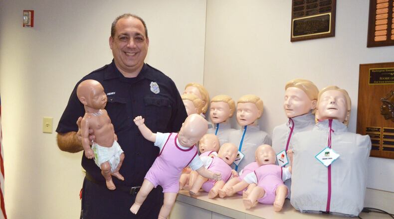 The Washington Twp. Fire Department has received new CPR Manikins that help students learn CPR by providing instant feedback on the quality of their compressions. Education Specialist Scott Henry is pictured holding the new and old infant manikins.