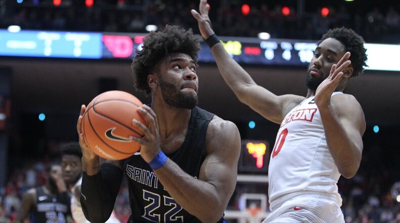 Saint Louis’ Hasahn French looks for a shot against Dayton’s Josh Cunningham on Tuesday, Feb. 20, 2018, at UD Arena. David Jablonski/Staff