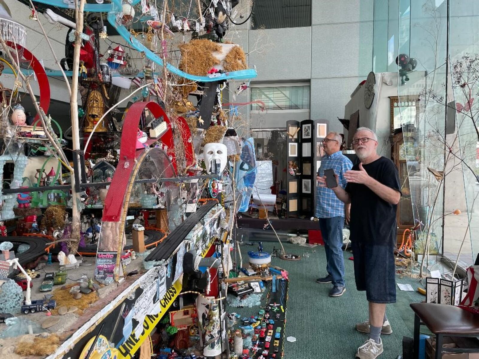 The Collaboratory founder Peter Benkendorf (left) and artist/writer John Drury assess Robert Blackstone's "Crystal City" installation. PHOTO BY RUSSELL FLORENCE JR.