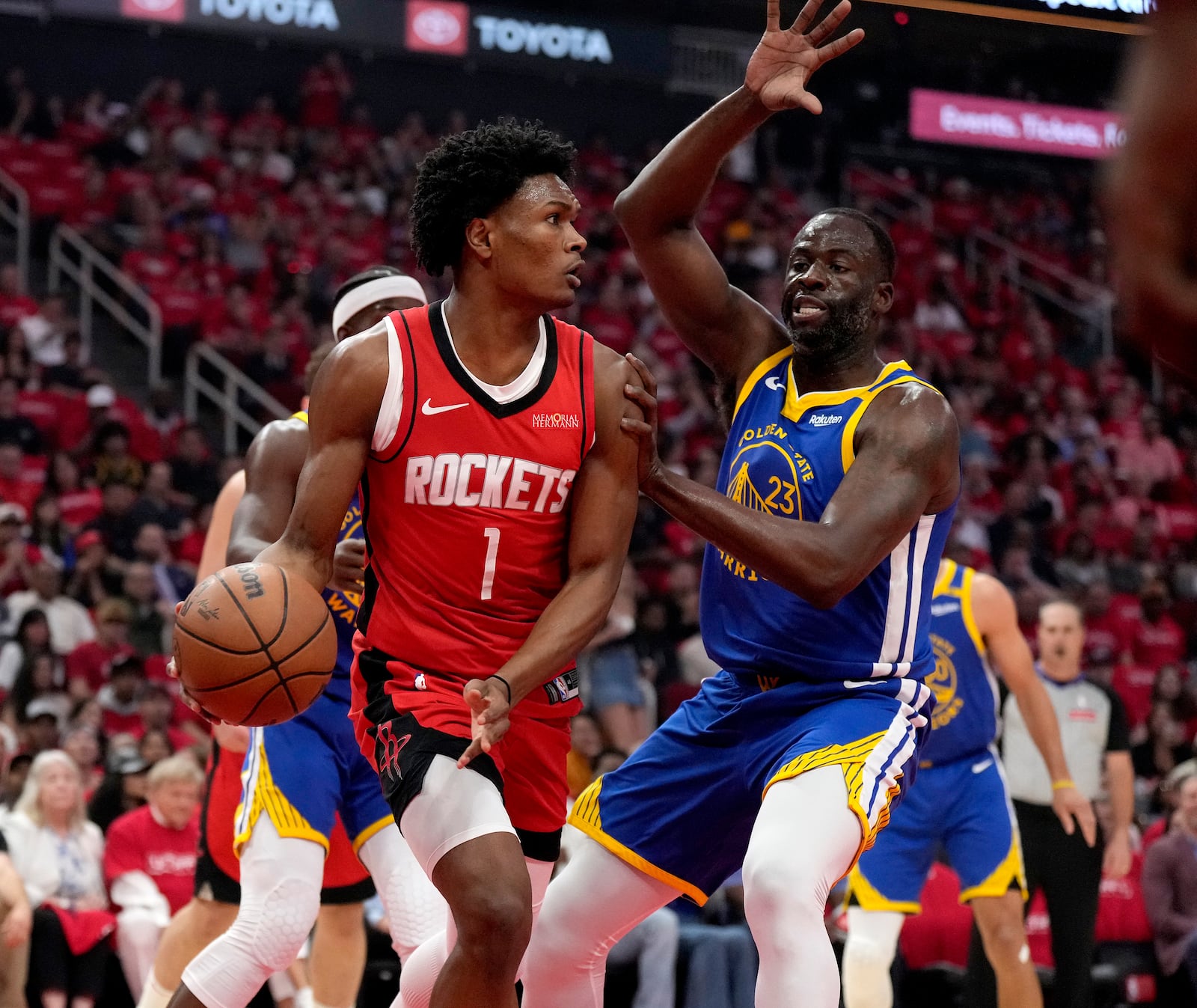 Golden State Warriors forward Draymond Green (23) defends against Houston Rockets guard Amen Thompson (1) during the first half of Game 2 of an NBA basketball first-round playoff series against the Houston Rockets in Houston, Wednesday, April 23, 2025. (AP Photo/Karen Warren)
