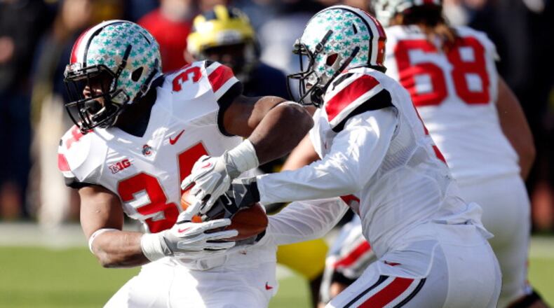 ANN ARBOR, MI - NOVEMBER 30: Quarterback Braxton Miller #5 hands the ball off to running back Carlos Hyde #34 of the Ohio State Buckeyes against the Michigan Wolverines during a game at Michigan Stadium on November 30, 2013 in Ann Arbor, Michigan. (Photo by Gregory Shamus/Getty Images)
