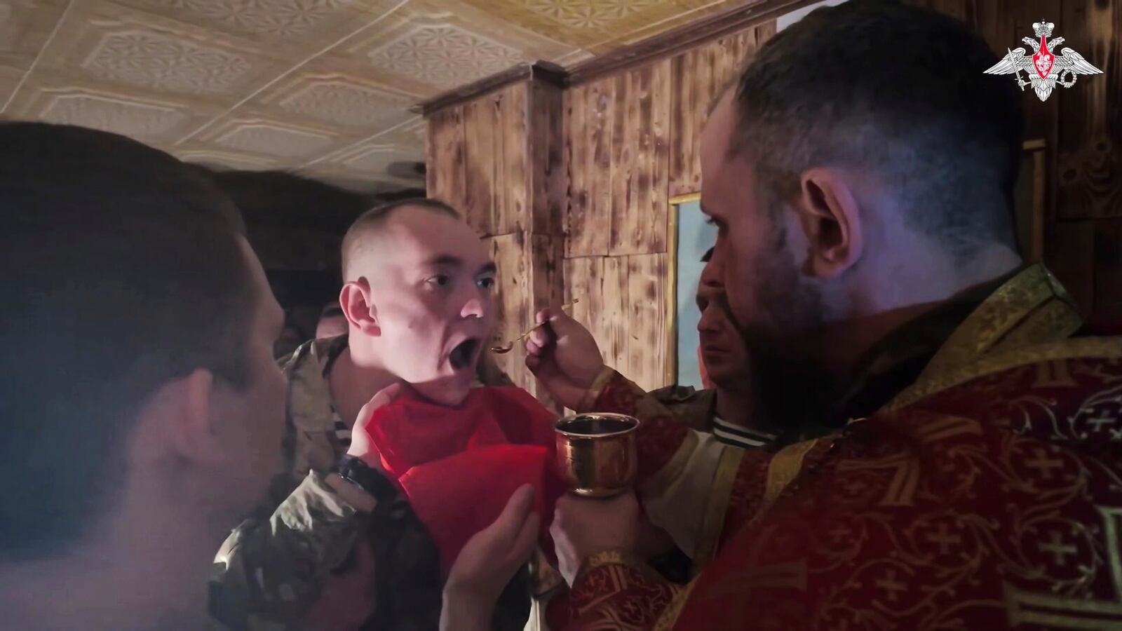 In this image from video distributed by the Russian Defense Ministry Press Service on Sunday, April 20, 2025, a Russian soldier gets an communion after a religion service on eve of Orthodox Easter at an unspecified location in Ukraine. (Russian Defense Ministry Press Service via AP)