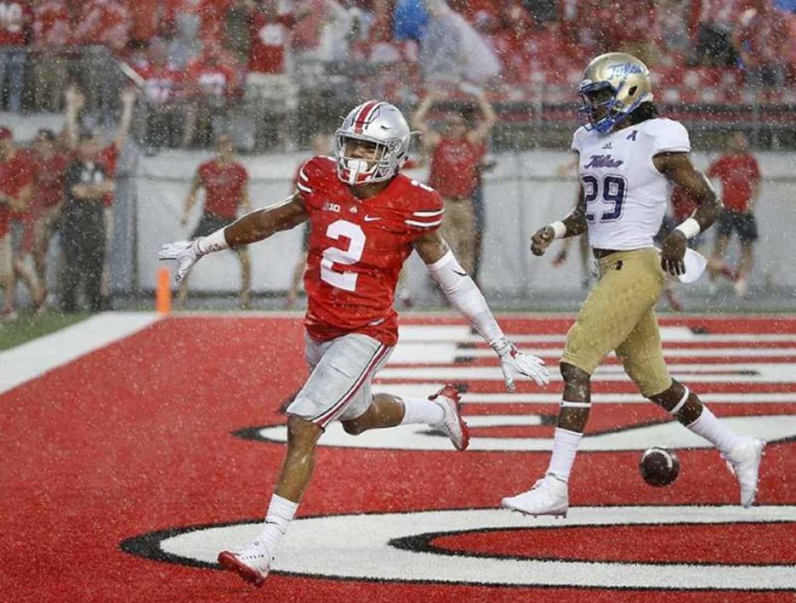 Ohio State cornerback Marshon Lattimore (2) celebrates in front of Tulsa Golden Hurricane wide receiver Justin Hobbs (29) after Lattimore returned an interception for a touchdown during the second quarter of the game. JONATHAN QUILTER | THE COLUMBUS DISPATCH