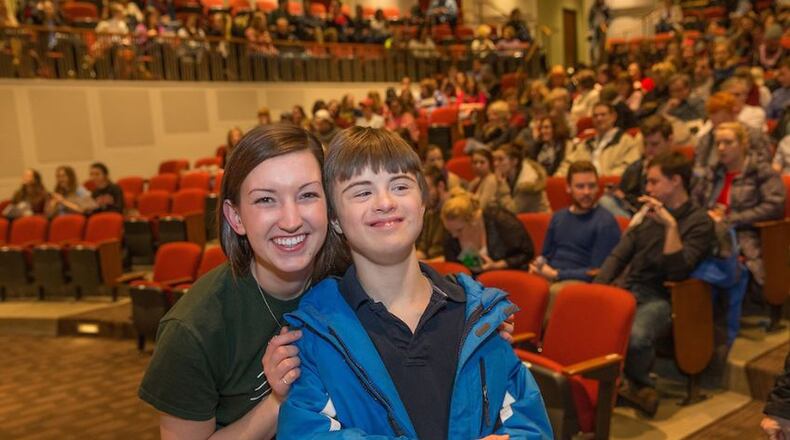 Tanner McClellan (left), founder of the Best Buddies Friends Choir, talks with Cam Scoggins, a member of the choir.