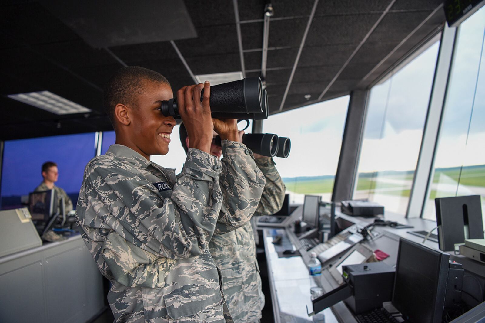 Cadets from the Civil Air Patrol’s 037 Wright-Patterson Composite Squadron look through binoculars at the flightline June 29 on Wright-Patterson Air Force Base. The cadets got an up-close tour of what happens behind the scenes at the 88th Operations Support Squadron’s base control tower. U.S. AIR FORCE PHOTO/AIRMAN 1ST CLASS ALEXANDRIA FULTON