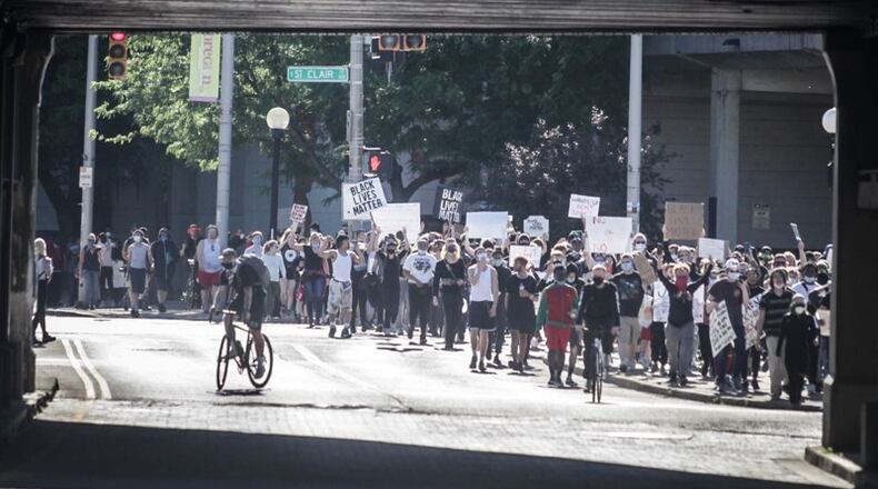 Protesters march on East Fifth Street in Dayton during a demonstration over the weekend.