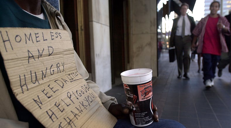 A panhandler begs for money December 5, 2001 in downtown Cincinnati. The city of Cincinnati is trying to come up with ways to combat the problem of panhandling which they say is keeping people from coming downtown to do their Christmas shopping. (Photo by Mike Simons/Getty Images)