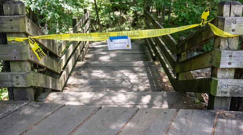 The trail head to the Devil's Den trail at Devils Den State Park remains closed Monday, July 28, 2025, in West Fork, Ark. Police in Arkansas are searching for a suspect in the deaths of a couple who investigators said were attacked while on the wooded walking trail with their two young daughters. (AP Photo/Michael Woods)