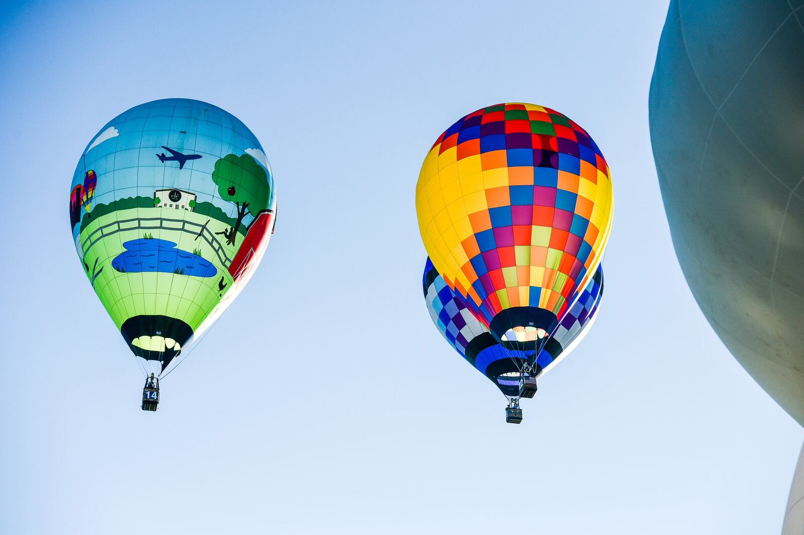 Competition balloons launched from off-site and flew over Hook Field to drop their markers as close to the target as possible Saturday morning during the Ohio Challenge Hot Air Balloon Festival at Smith Park in Middletown. Special shape balloons inflated on-site for attendees to get a closer look at them. NICK GRAHAM/STAFF