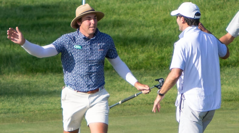 Grant Haefner celebrates with his caddy after putting in a long birdie from the fringe to secure a two-shot victory in Monday's U.S. Open final qualifier at Springfield Country Club. Jeff Gilbert/CONTRIBUTED