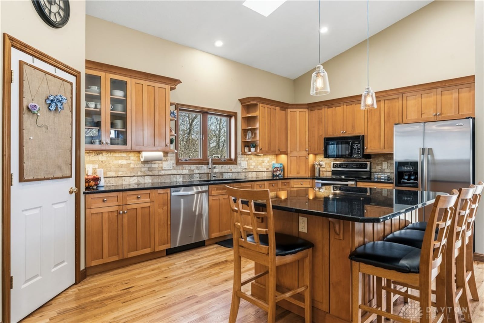 The addition features a kitchen with hardwood floors, custom wood cabinets, granite counters and a tile backsplash. There is a pantry and an island with bar seating, recessed lighting and a vaulted ceiling. CONTRIBUTED