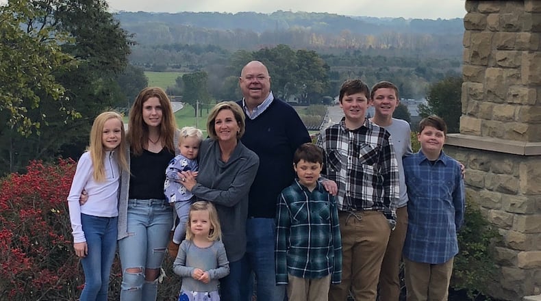 Bob Mills and wife Barbara with their eight grandchildren. CONTRIBUTED