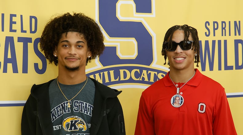 Springfield's Da Shawn Martin, left, signed his letter of intent to play football at Kent State University and Aaron Scott signed to play for Ohio State Wednesday, Dec. 20, 2023. BILL LACKEY/STAFF