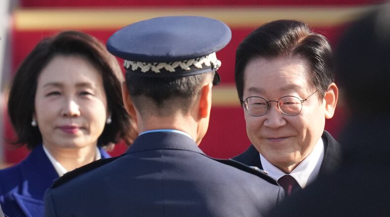 South Korean President Lee Jae Myung and his wife Kim Hea Kyung are greeted before leaving for China at the Seoul airport in Seongnam, South Korea, Sunday, Jan. 4, 2026. (AP Photo/Lee Jin-man)