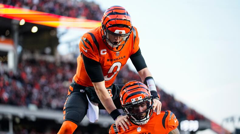 Cincinnati Bengals wide receiver Tee Higgins (85) and quarterback Joe Burrow (9) celebrate a touchdown against the Kansas City Chiefs in the first half of an NFL football game in Cincinnati, Sunday, Dec. 4, 2022. (AP Photo/Joshua Bickel)