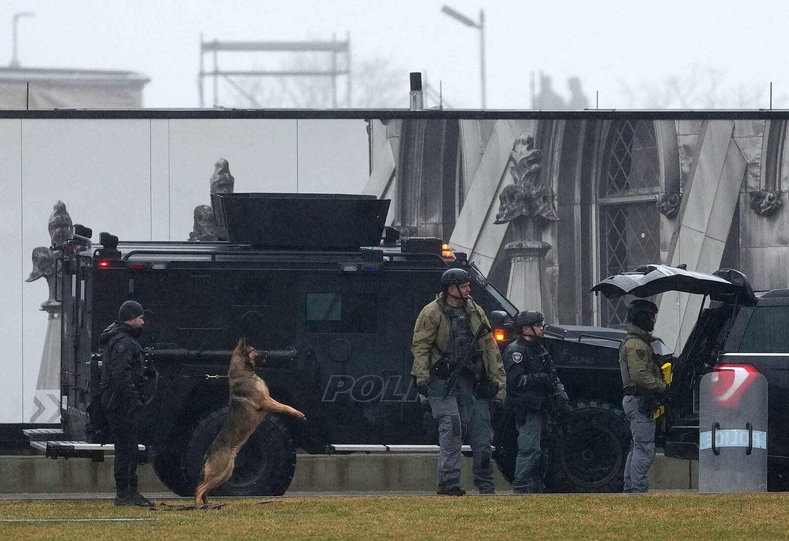 Law enforcement and a police dog respond to a man barricaded inside the East Block on Parliament Hill in Ottawa, Ontario, Saturday, April 5, 2025. (Justin Tang/The Canadian Press via AP)