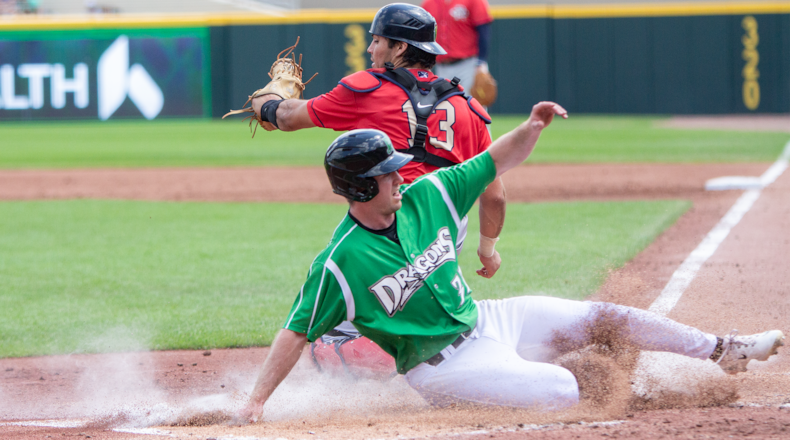Jacob Hurtubise, on a minor-league rehab assignment from Louisville, is safe at home on a double steal as Cedar Rapids catcher Nate Baez sees that the throw is late. Jeff Gilbert/CONTRIBUTED