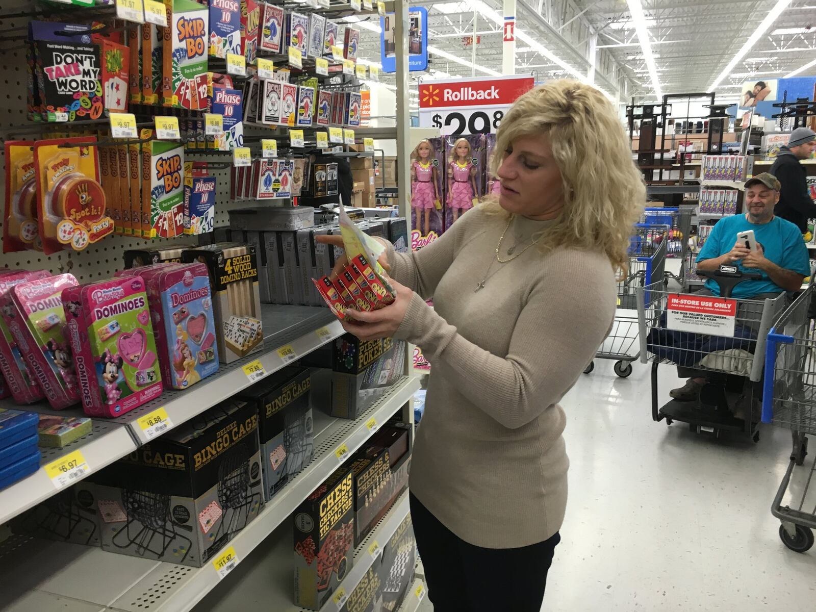 Kayla Harrison, a two-time Olympic gold medalist, and her niece, Kyla, and her boyfriend, Quentin Leahy, 27, spent Friday morning at the Middletown Walmart buying Christmas presents for less fortunate children. RICK McCRABB/STAFF