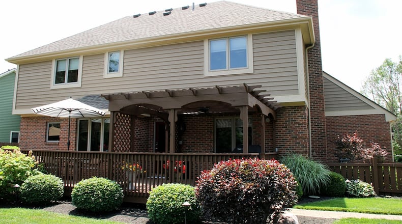 Patio doors off the family room open to the wood deck with a pergola.