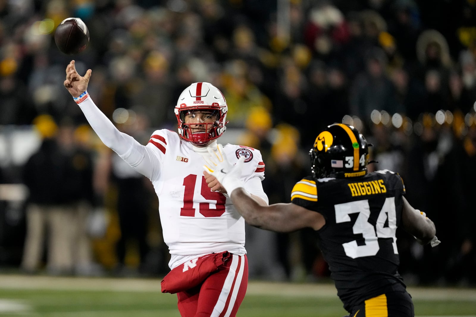 FILE - Nebraska quarterback Dylan Raiola (15) throws a pass over Iowa linebacker Jay Higgins (34) during the first half of an NCAA college football game, Nov. 29, 2024, in Iowa City, Iowa. (AP Photo/Charlie Neibergall, File)
