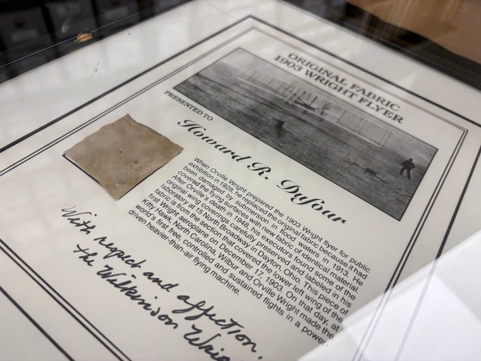 A piece of fabric from an early Wright flyer presented to Howard DuFour,  of New Carlisle, a machinist who once worked on the Manhattan Project for the Atomic Energy Commission. The fabric is part of Wright State University's Wright brothers collection of artifacts. THOMAS GNAU/STAFF