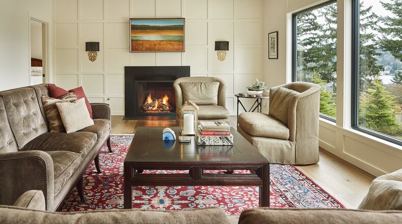 The ceiling rose to 9 feet in the living area, which can join with the guest bedroom to form a full suite behind French doors. “I love the proportions,” says homeowner Anne Tucker. “We reorganized the space to make it more graceful.” The art over the fireplace actually is the back of a TV.