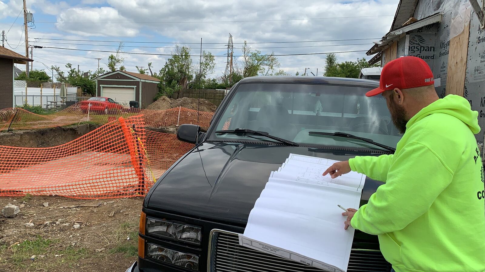 Steven Young, construction supervisor at Habitat for Humanity of Greater Dayton, displays the plans for rebuilding a house on Macready Avenue in Old North Dayton that was demolished because of damage from the Memorial Day 2019 tornadoes.
