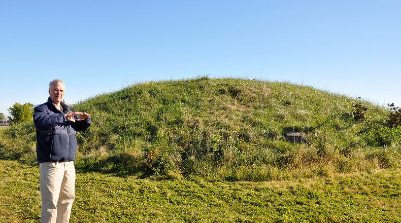 Erwin Roemer, Cultural Resources subject matter specialist, stands next to the largest mound at Wright-Patterson Air Force Base, located on the north corner of Hobson Way and Ninth Street, Area B. Roemer explained the Native American tribes wanted the trees cut down so the roots would not damage the mound. This mound is the third largest mound in the Miami Valley, and it is believed this mound’s location and those of the Wright Brothers Memorial were placed intentionally relative to each other. (U.S. Air Force photo/W. Eugene Barnett)