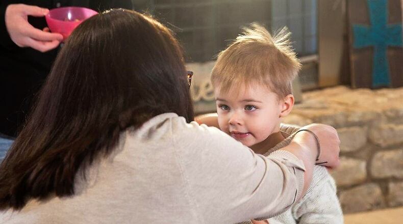 Cyndi Swafford of Englewood, helps her adopted son Judah. He was born addicted to drugs and came to the Swafford family as a foster child. MICHAEL BURIANEK/STAFF