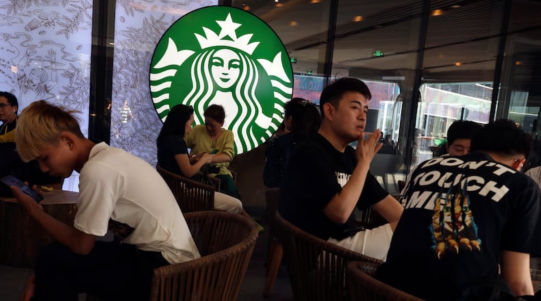 FILE - Chinese customers enjoy their drinks at a store of U.S. coffee giant Starbucks in Beijing on May 10, 2019. (AP Photo/Ng Han Guan, File)