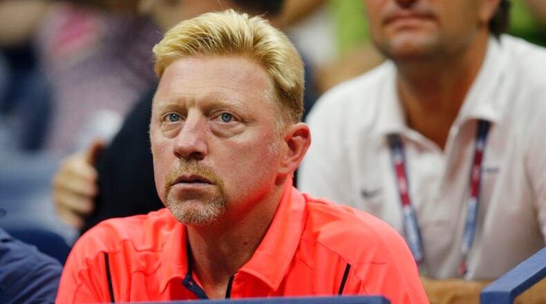 Boris Becker watches from the stands as Novak Djokovic, of Serbia, faces Andreas Haider-Maurer, of Austria, in the U.S. Open tennis tournament in New York, Wednesday, Sept. 2, 2015. (AP Photo/Kathy Willens)