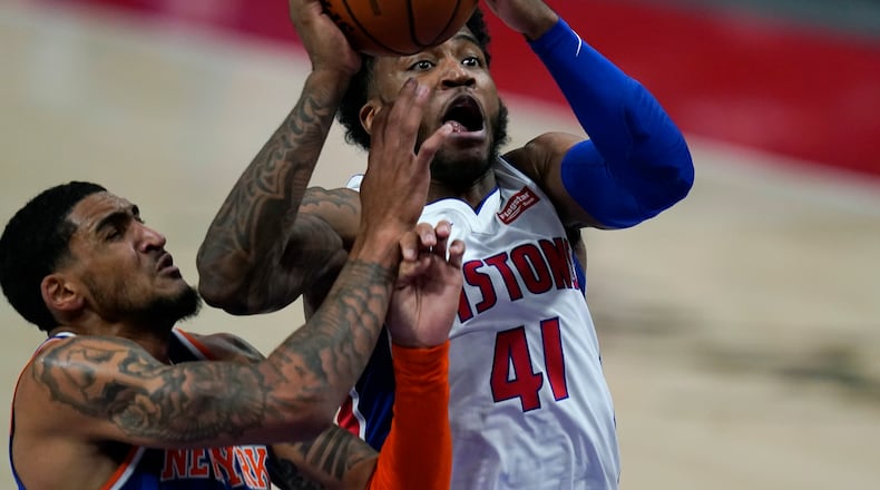 Detroit Pistons guard Saddiq Bey (41) attempts a layup as New York Knicks forward Obi Toppin defends during the second half of a preseason NBA basketball game, Friday, Dec. 11, 2020, in Detroit. (AP Photo/Carlos Osorio)