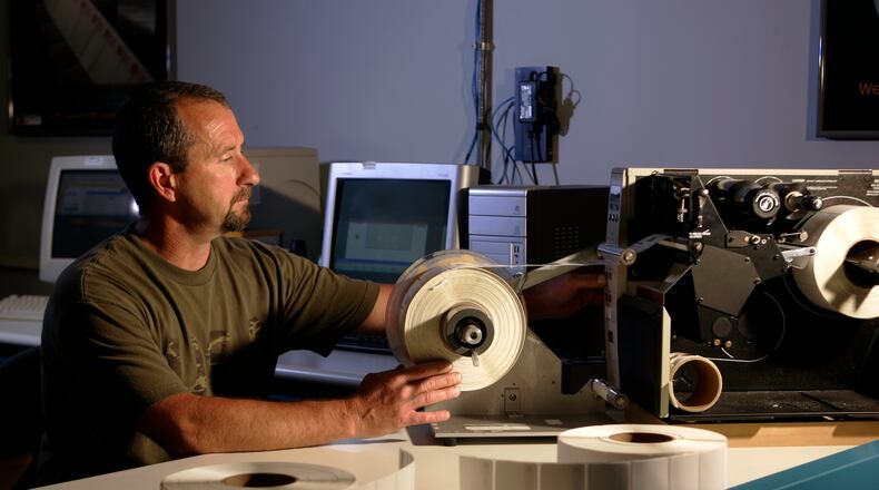 Repacorp RFID Plant Manager Gary Parrott operates an RFID enabled incoder imprinter during production in the company’s Tipp City plant in this file photo. Photo by Jim Witmer