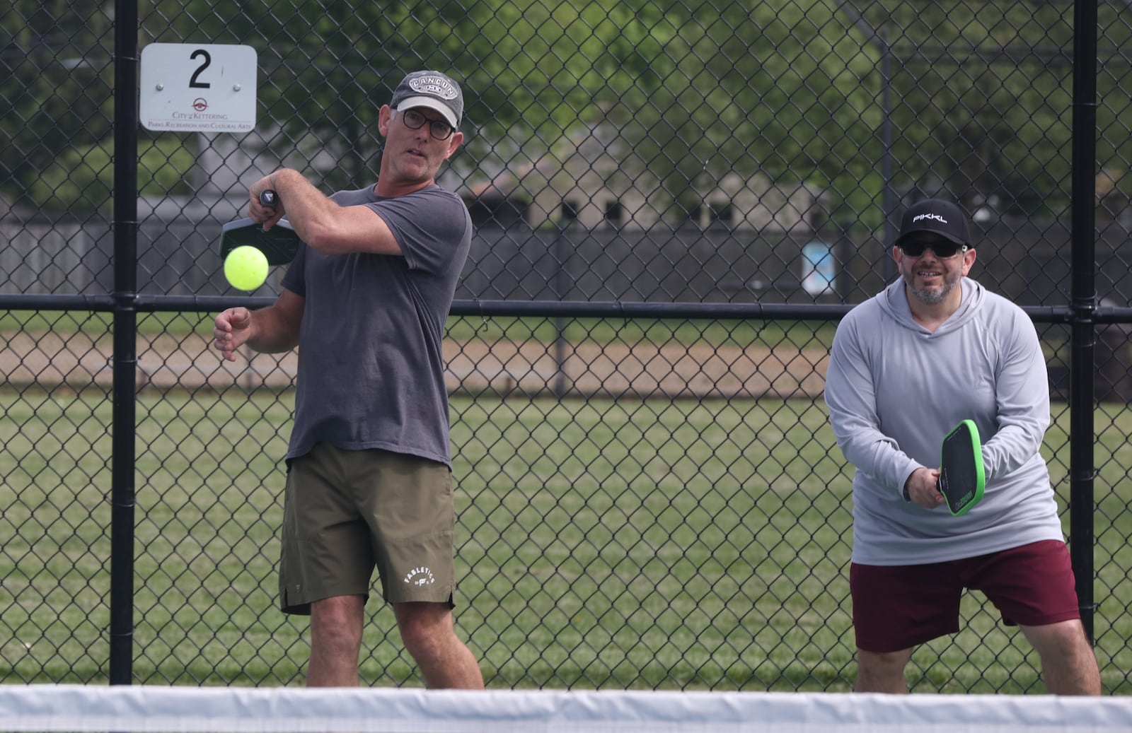 Jake Burns, left, of Springfield, and Michael Sherr, right, of Cedarville, play pickleball at J.F. Kennedy Park on May 8, 2025, in Kettering. David Jablonski/Staff