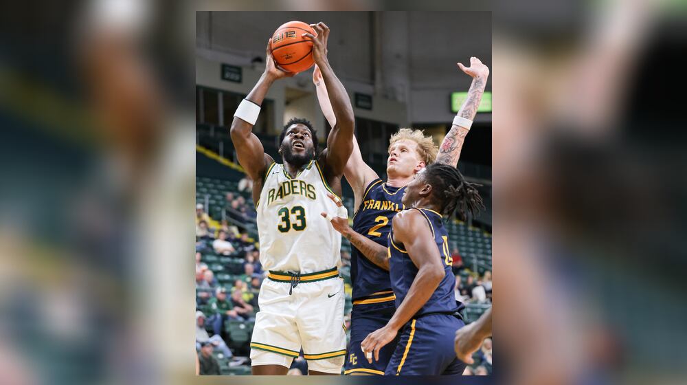 Wright State forward Michael Imariagbe shoots with pressure from Franklin College's Jesse Faires (right) and LeBron Bennie-Powell during a season opener on Monday, Nov. 3 at Ervin J. Nutter Center. Imariagbe led the squad with 13 points and had four rebounds in a little over 15 minutes of action in a 86-37 win. BRYANT BILLING/STAFF