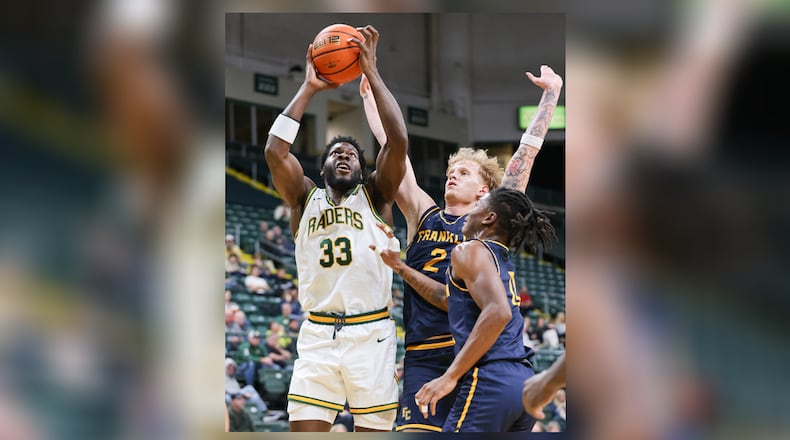 Wright State forward Michael Imariagbe shoots with pressure from Franklin College's Jesse Faires (right) and LeBron Bennie-Powell during a season opener on Monday, Nov. 3 at Ervin J. Nutter Center. Imariagbe led the squad with 13 points and had four rebounds in a little over 15 minutes of action in a 86-37 win. BRYANT BILLING/STAFF