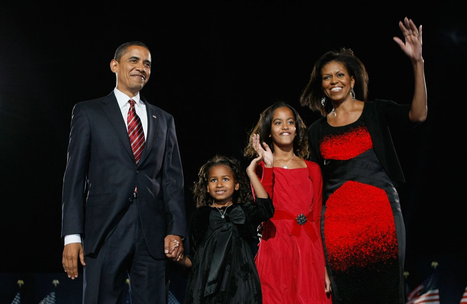 U.S. President elect Barack Obama (L) stands on stage along with his wife Michelle (R) and daughters Malia (2nd R) and Sasha during an election night gathering in Grant Park on November 4, 2008 in Chicago, Illinois. Obama defeated Republican nominee Sen. John McCain (R-AZ) by a wide margin in the election to become the first African-American U.S. President elect. (Photo by Joe Raedle/Getty Images)