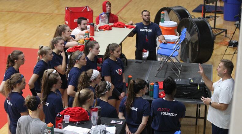Dayton volleyball players gather around Tim Horsmon on Wednesday, Sept. 26, 2018, at the Frericks Center. David Jablonski/Staff