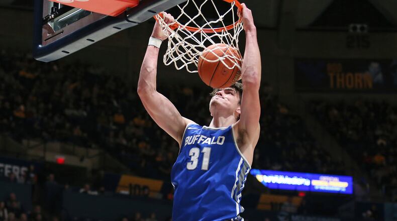 Buffalo center Isaac Jack dunks against West Virginia during the first half of an NCAA college basketball game in Morgantown, W.Va., Sunday, Dec. 18, 2022. (AP Photo/Kathleen Batten)