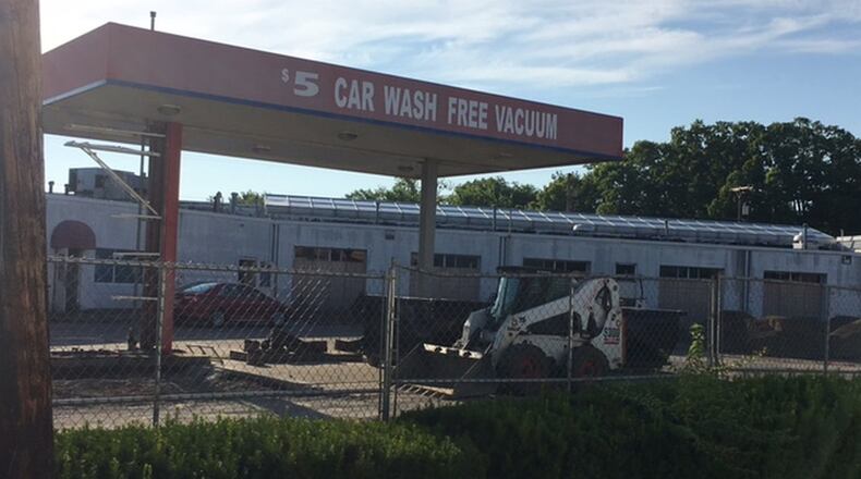 The first phase of a demolition of a former car wash has started as part of a three-way deal that will bring a Kettering Health Network office building to West Carrollton. NICK BLIZZARD/STAFF