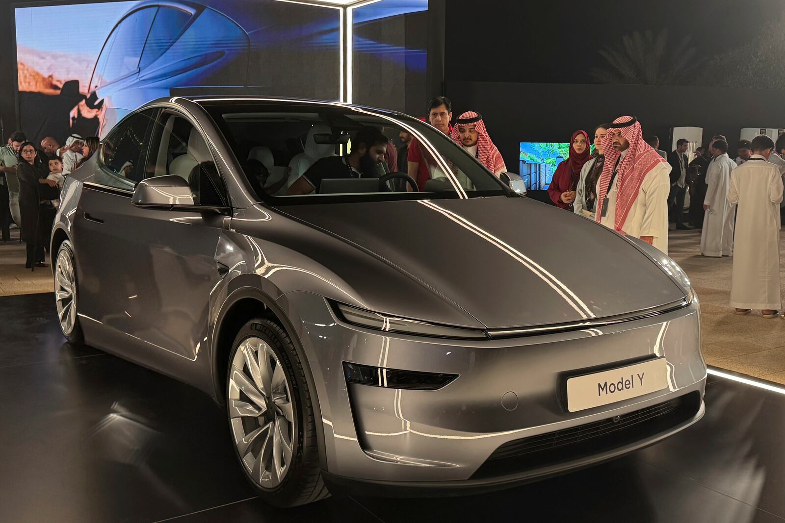 People attend a celebration for the start of Tesla operations in Saudi Arabia in historic Diriyah near Riyadh, Saudi Arabia, on Thursday, April 10, 2025 (AP Photo/Baraa Anwer)