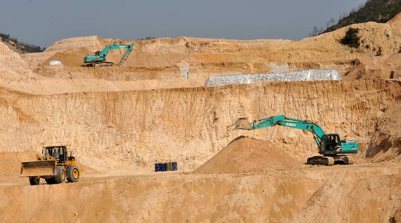 FILE - Workers use machinery to dig at a rare earth mine in Ganxian county in central China's Jiangxi province on Dec. 30, 2010. (Chinatopix via AP, File)
