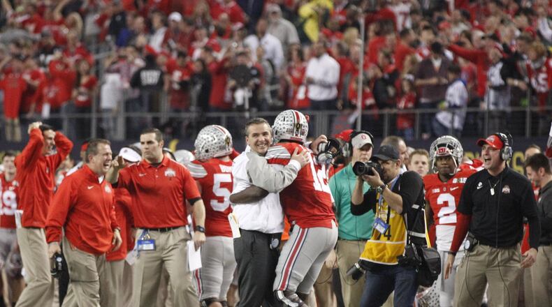 Ohio State coach Urban Meyer and quarterback Cardale Jones hug in the final minute of Ohio State’s 42-20 victory over Oregon in the national championship game on Monday, Jan. 12, 2015, at AT&T Stadium in Arlington, Texas. David Jablonski/Staff