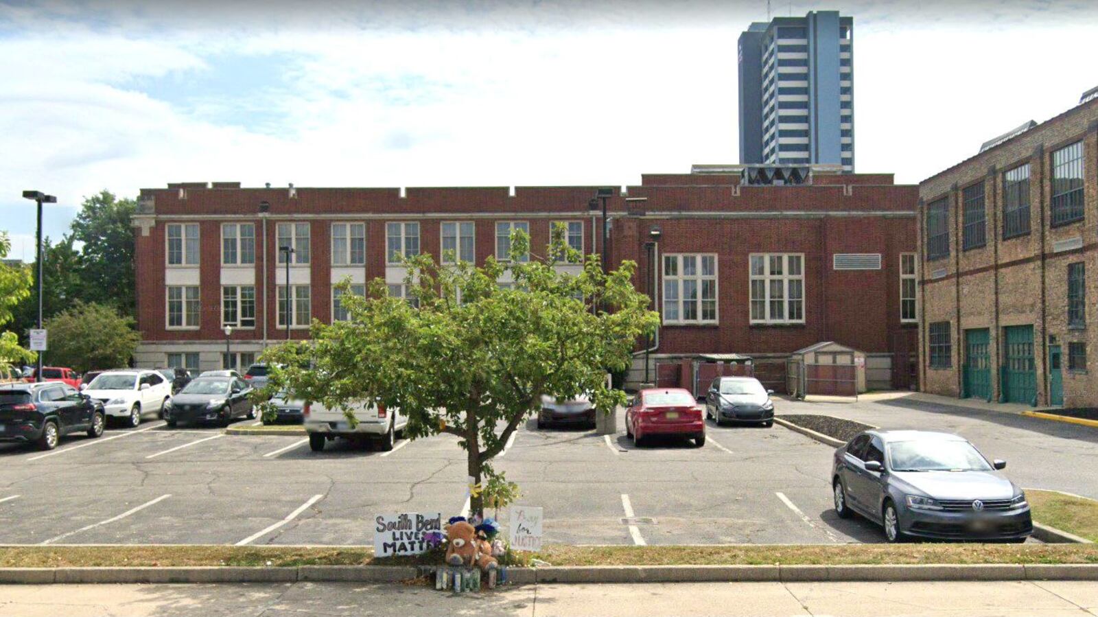 A memorial to Eric Logan is pictured at the edge of a South Bend, Ind., parking lot in this August 2019 Street View image. Logan, 54, was shot and killed June 16, 2019, by South Bend police Officer Ryan O'Neill, who has been cleared in the shooting. (Google)
