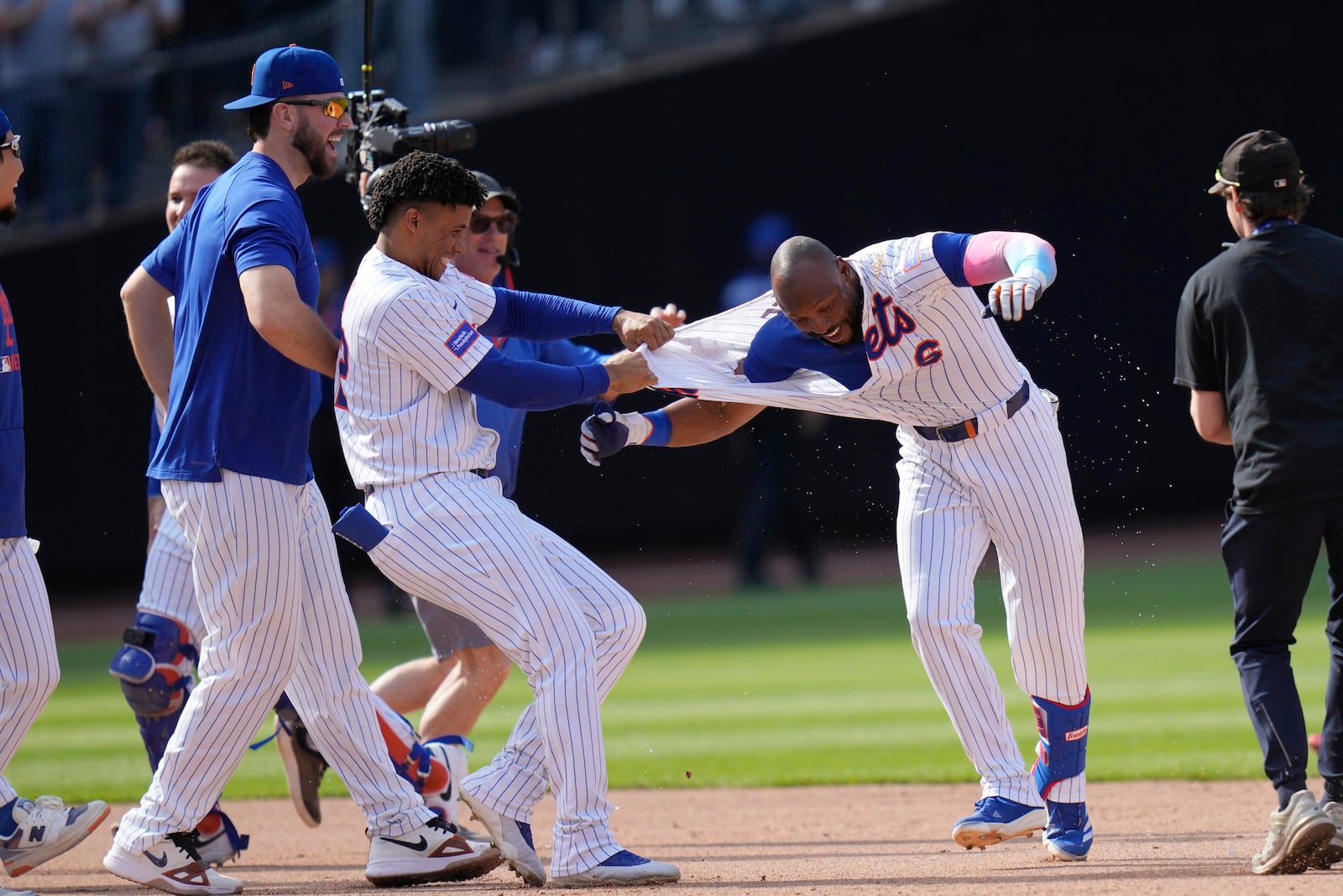 New York Mets' Starling Marte, right, celebrates with teammates after hitting a walk-off single during the tenth inning of a baseball game against the Philadelphia Phillies, Wednesday, April 23, 2025, in New York. (AP Photo/Seth Wenig)